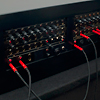 <p style='text-align: left; margin-bottom: -10px;'>Each side of the switchboard contains a Music From Outer Space ten step sequencer, with some added features such as external trigger inputs and pulse outs on each step.  They can run independantly or in sync with each other. </p><br>Photo by Seze Devres